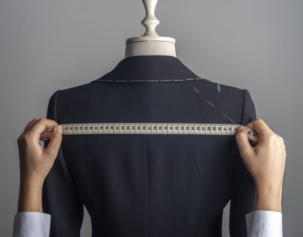 Tailor measuring suit jacket representing Payl8r customised finance solutions for your business
